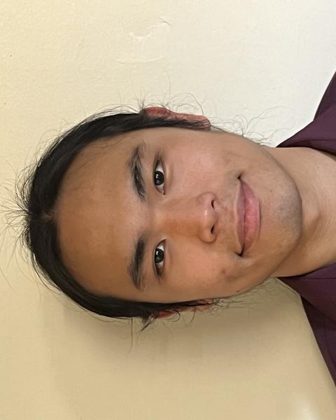 Man standing against the wall smiling