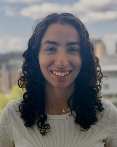 Woman with long curly hair smiling