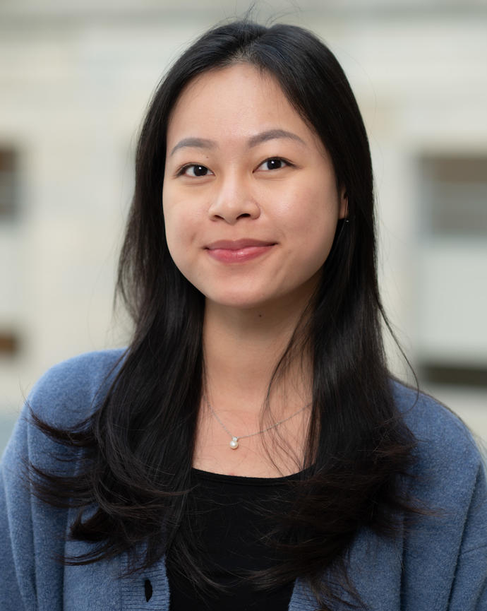 Woman with long hair in blue blazer smiling