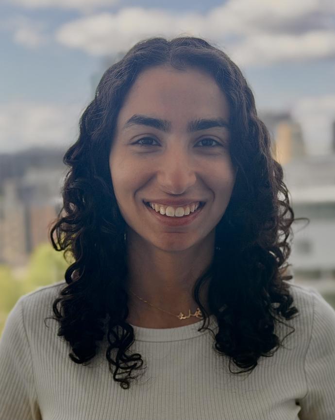 Woman with long curly hair smiling